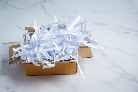 Shredded paper in a box on a marble floor