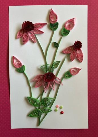 Illustrative depiction of pink petal flowers as depicted with "quilling" rafting technique, engineering the flower shapes out of spiraled strips of paper