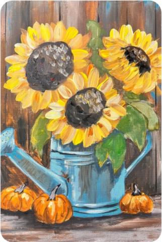 Painting of three large sunflowers in a watering can depicted with vibrant colors and thick strokes, three small pumpkins sat around the base of the can