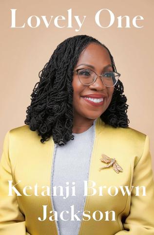 Cover image for the book "The Lovely One," featuring a photograph of the author and subject of the book, U.S. Supreme Court justice Ketanji Brown Jackson, as viewed from the bust up in a light yellow blazer with a dragonfly pin, looking off to the right with a bright, smiling face