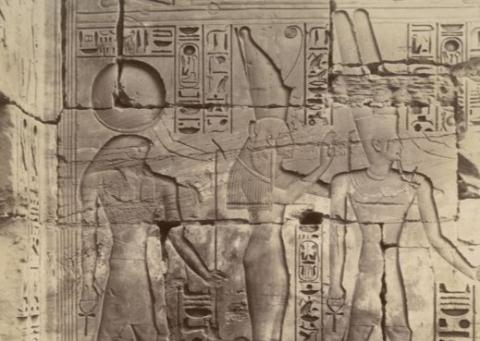 "Bas relief du Temple du Thautmos III a Karnak," courtesy of the New York Public Library Digital Collections, depicting a stone carving of  Egyptian gods and kings posed side-by-side in profile beside a series of hieroglyphics