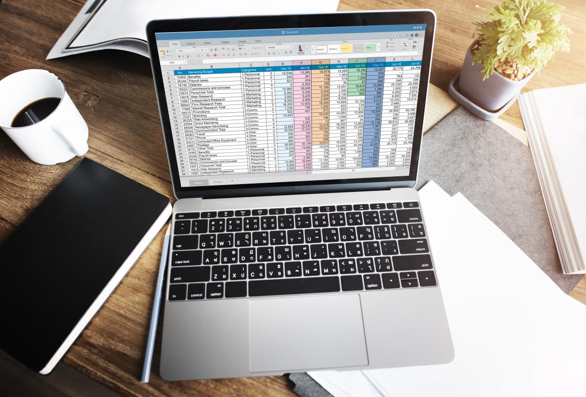 Aerial view of a laptop with an organized Excel document open on the screen